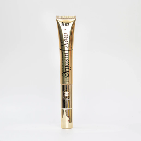 A sleek, vertical gold tube of Intt Orgasm Now Female Enhancement Gel (0.5 fl oz) featuring a metallic gold finish and a visible power switch for the vibrating tip applicator, centered on a solid white background.