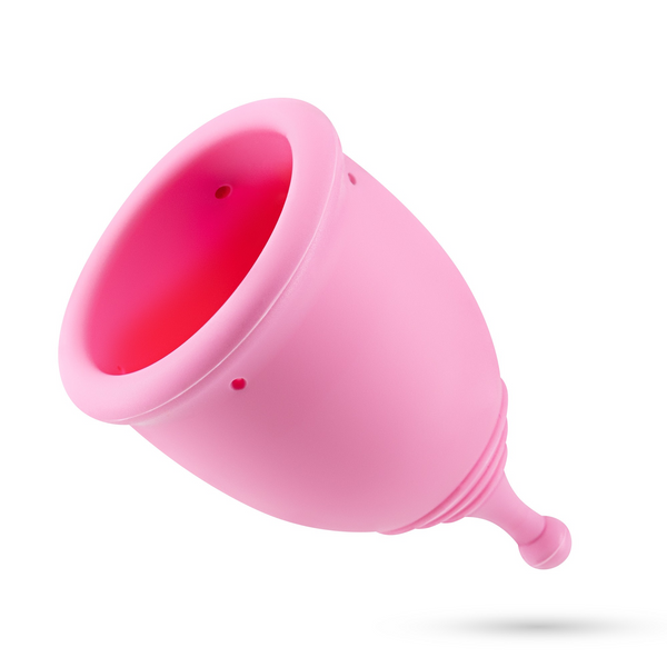 A single pink menstrual cup, tilted, on a white background.