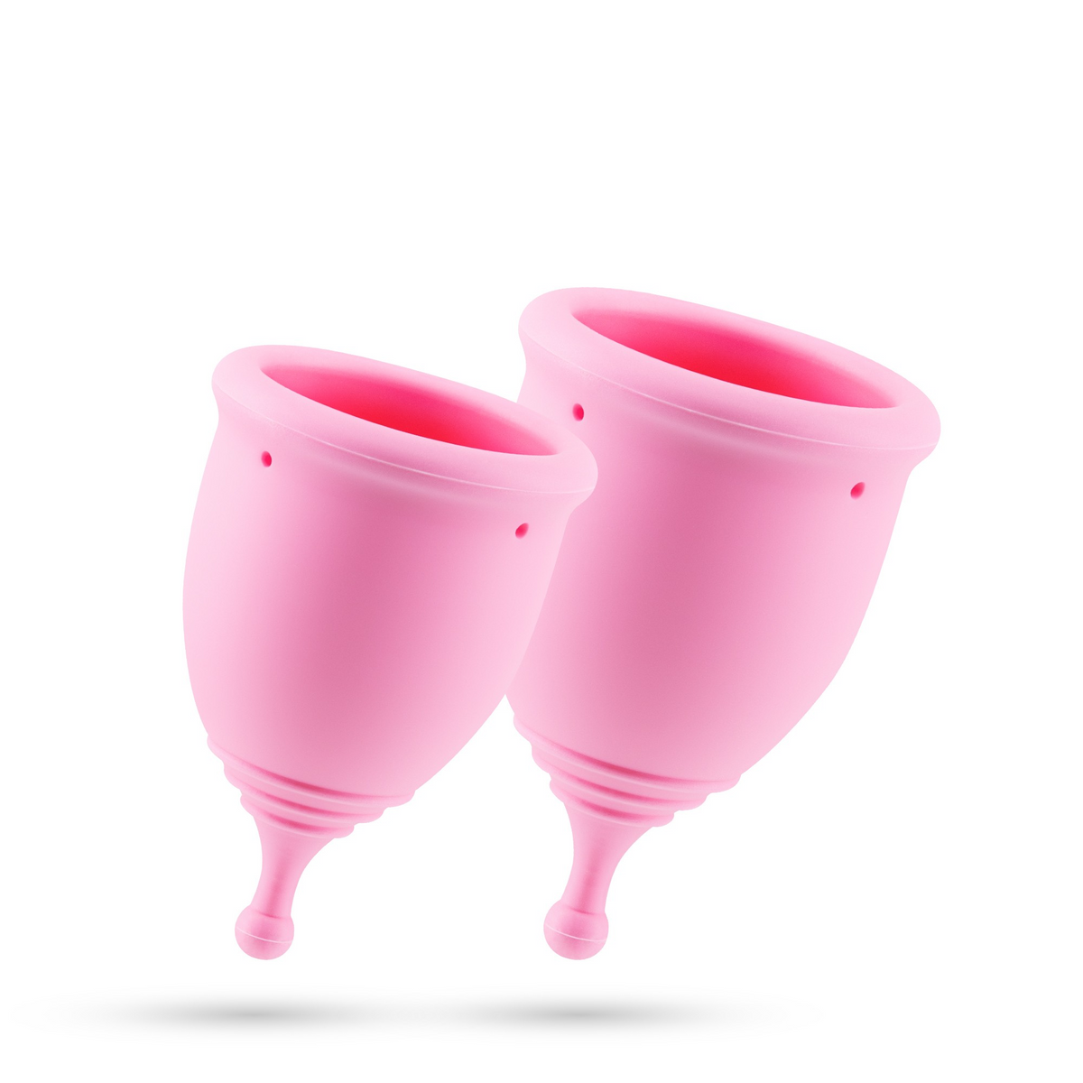 Two pink menstrual cups floating together on a white background.