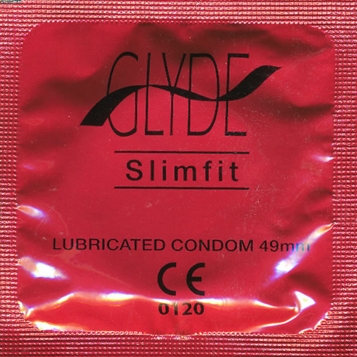 A close-up of a single Glyde Slimfit condom wrapper. The wrapper is red. The word "GLYDE" is written in black capital letters. Below it, the word "Slimfit" is written in black. The wrapper also states "LUBRICATED CONDOM 49mm" and has the "CE 0120" mark.