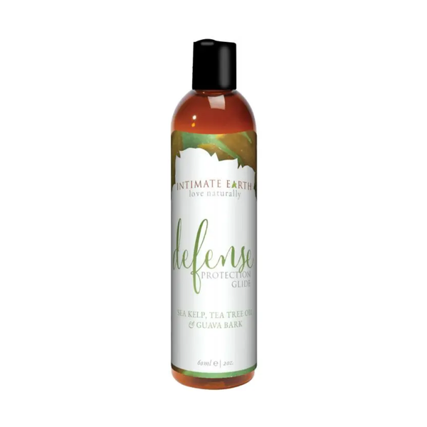 Front studio view of the travel-sized 60 ml (2 fl oz) amber bottle of Intimate Earth Defense protection glide with a black cap.