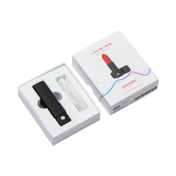 Unboxing photo showing the capped Lovense Exomoon vibrator and USB charging cable in white tray packaging next to the box lid.