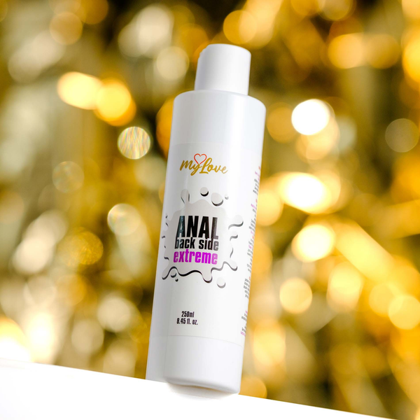 Front view of the 250 ml MyLove Anal Back Side Extreme bottle set against a warm, heavily blurred golden backdrop.