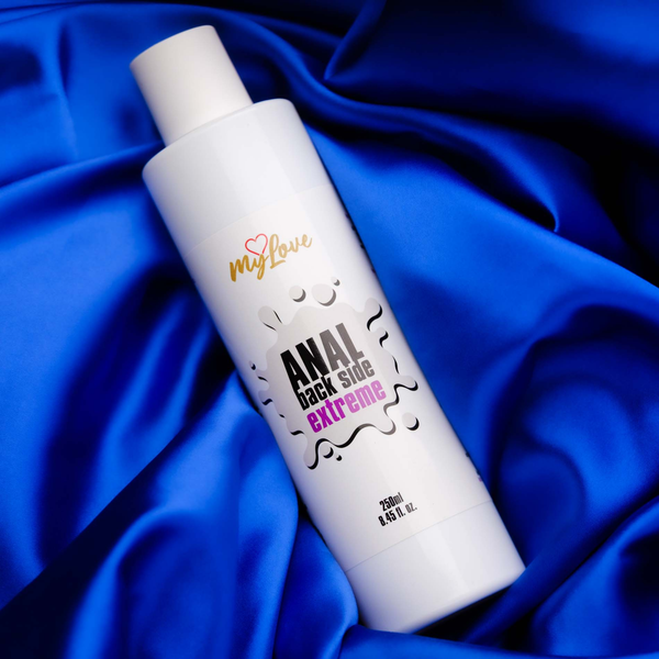 The 250 ml bottle of MyLove Anal Back Side Extreme gel rests at an angle on draped, vibrant royal blue satin fabric.