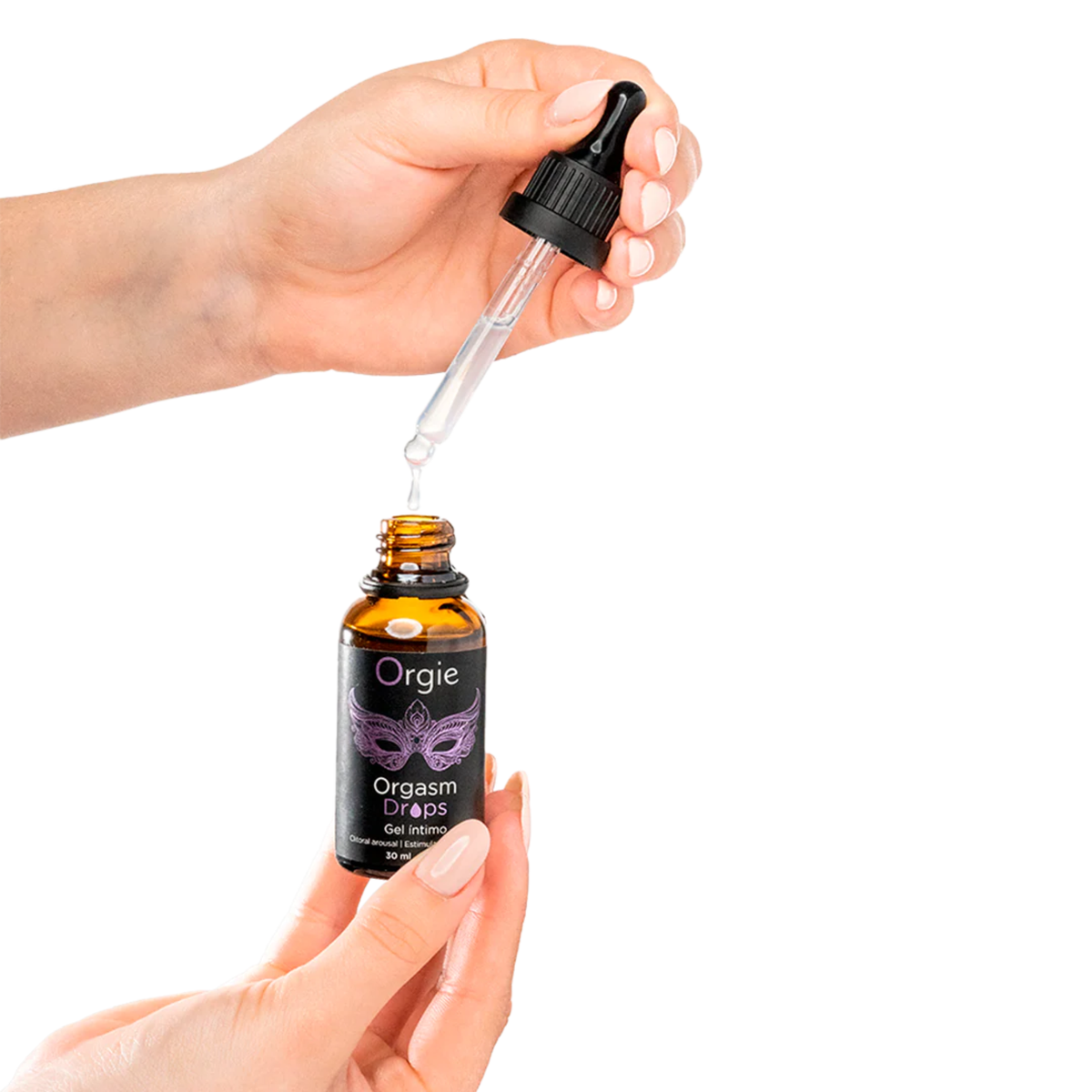 A pair of hands holding the Orgie Orgasm Drops bottle, with the dropper dispensing a drop of liquid into the bottle.