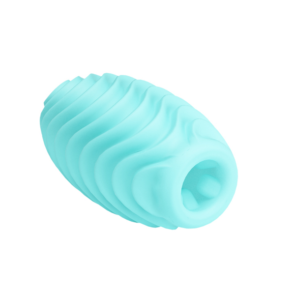 Angled studio shot of the flexible light blue masturbation egg lying on its side, showing its wavy exterior ridges and textured interior opening.