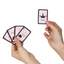 Hands holding secret play mini Kamasutra playing cards with a joker card on a white background