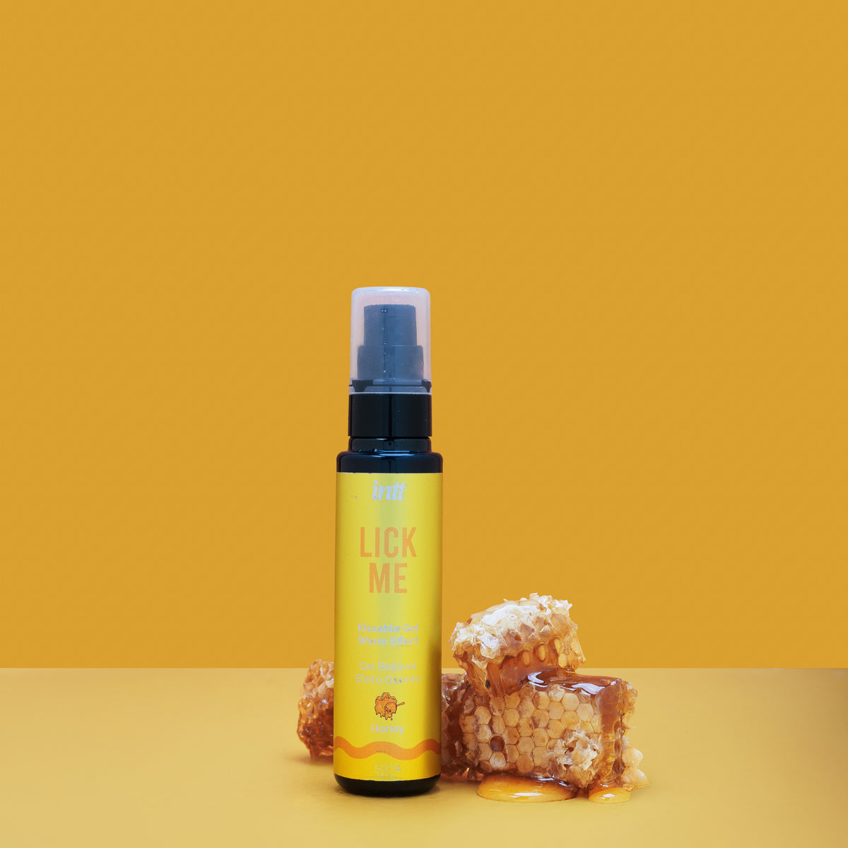 Bottle labeled 'Lick Me' with honeycomb on a yellow background