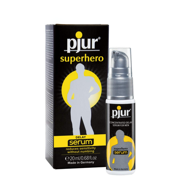 A black box and clear pump bottle of Pjur Superhero Delay Serum are shown against a white background.