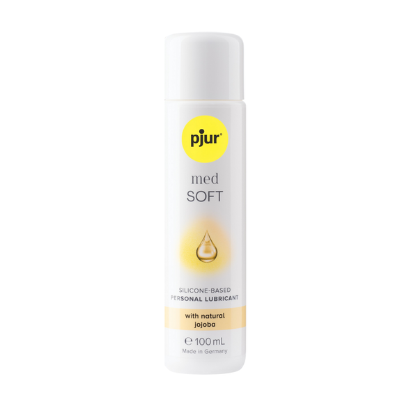 A white bottle of pjur med SOFT water-based personal lubricant with a yellow logo and light orange accents on a white background.