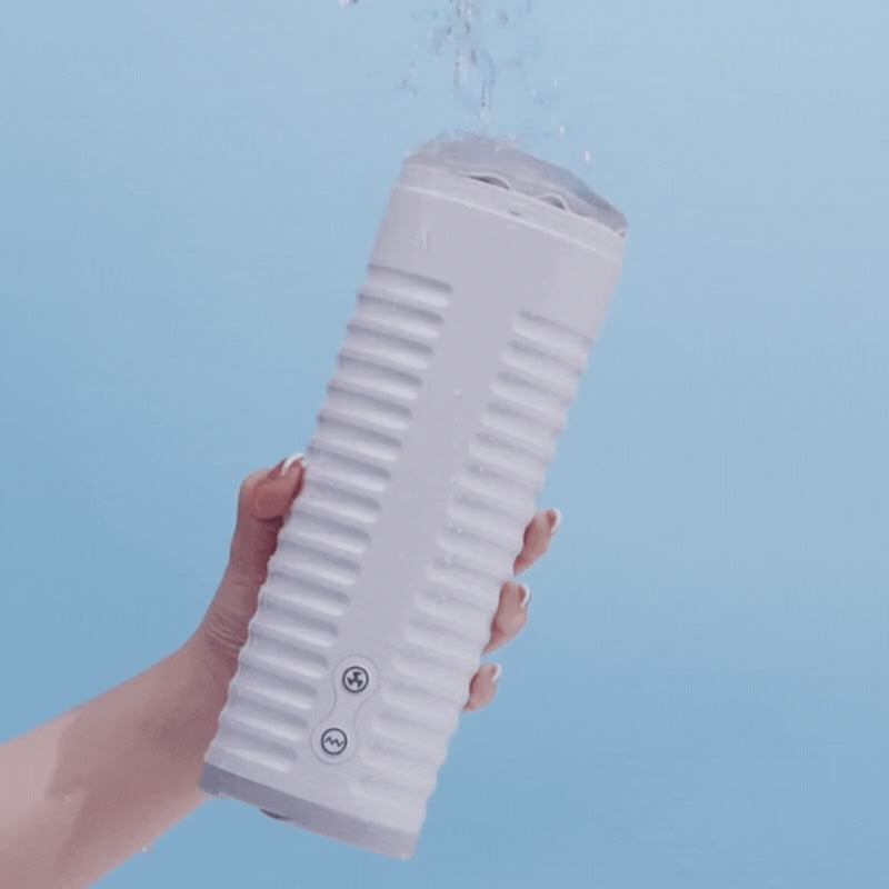 Video showing a hand holding the white Lovense Max 2 masturbator under running water against a light blue background.